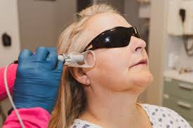 Patient undergoing laser therapy for TMJ, featuring cold laser for TMJ pain relief with advanced TMJ laser treatment.